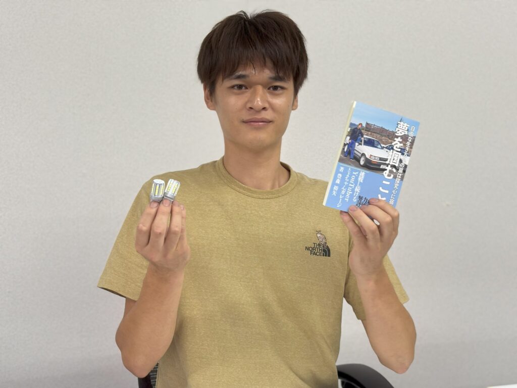 HID屋のバルブと自信の書籍「夢を掴むこと」を持つとよちゃんガレージさん