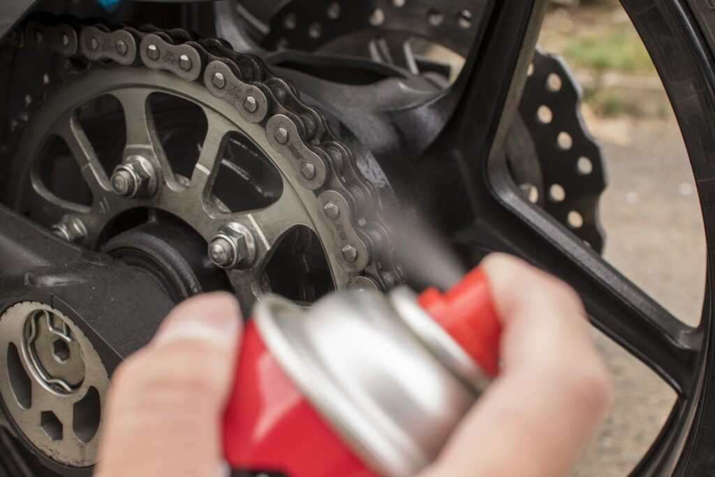 バイクのチェーンに注油する様子