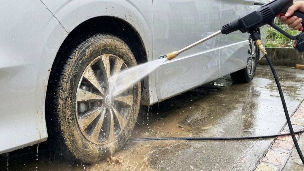 高圧洗浄機で車のタイヤを洗っている様子